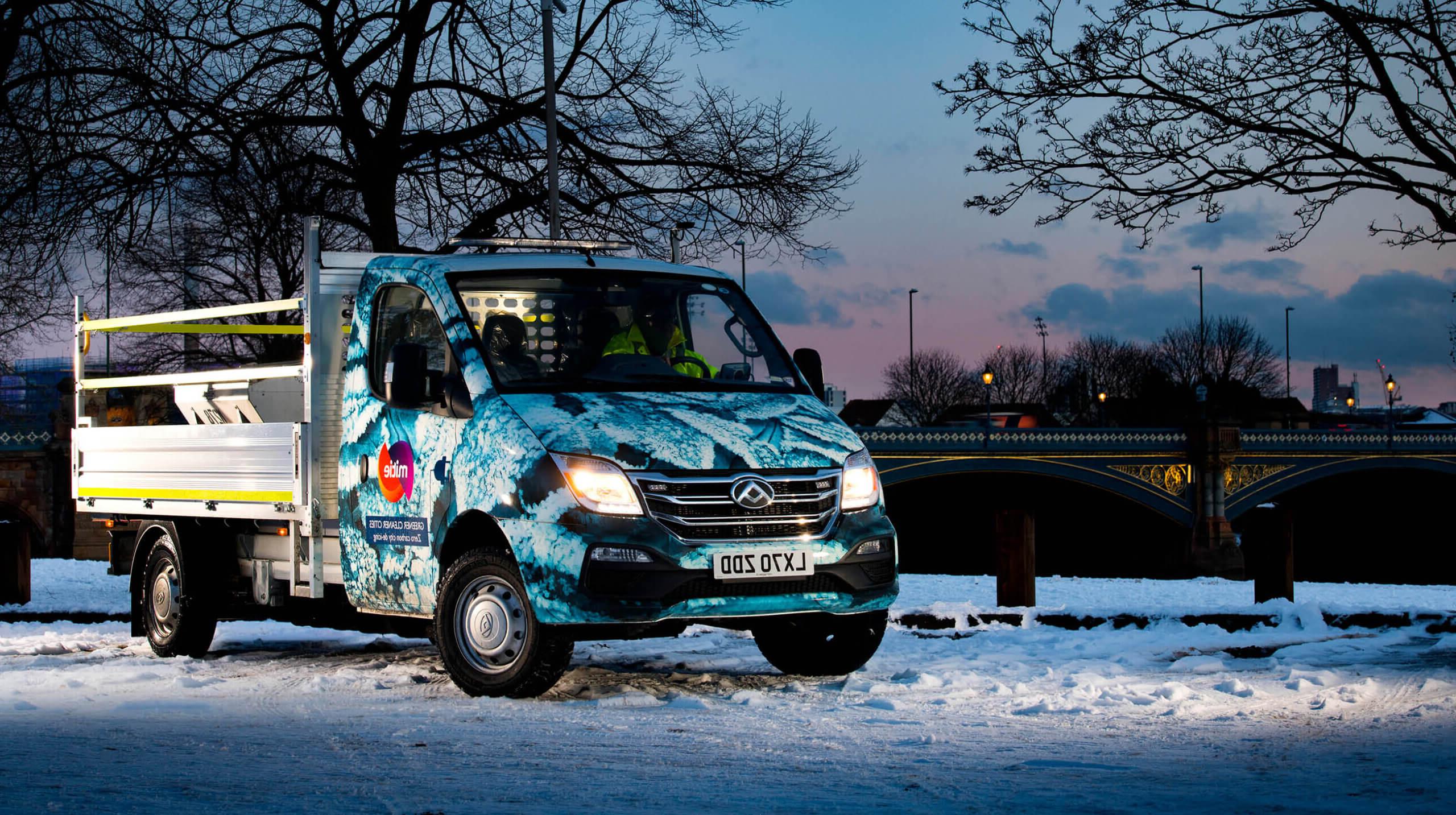 Mitie branded van in a snowy landscape, with the cab decorated with a snowflake pattern